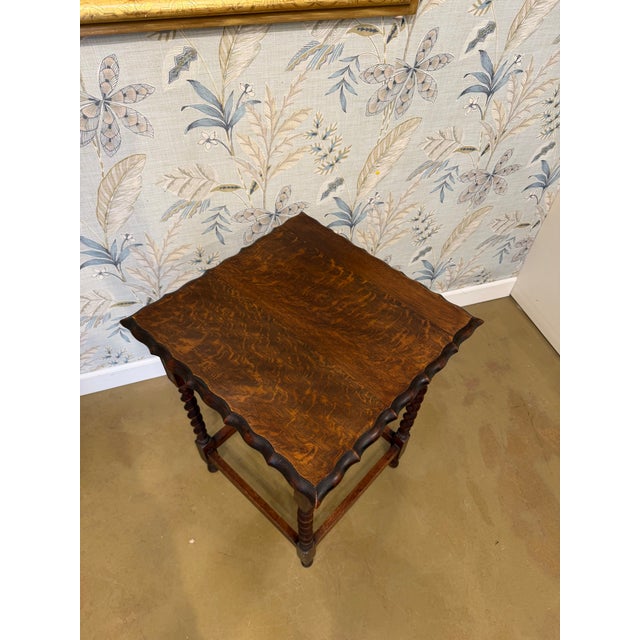 Such a lovely piece of history, this side table features distinctive barley twist legs and a delicate scalloped top. This...