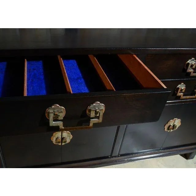 This Asian style buffet has four drawers above two sets of lower cabinet doors. It was manufactured by Landstrom Furniture...