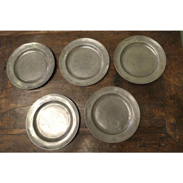 5 Pewter Chargers, Embossed with a “Crown over D” Antique English pewter plates, the front rim is engraved with a Crown...