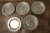 5 Pewter Chargers, Embossed with a “Crown over D” Antique English pewter plates, the front rim is engraved with a Crown...