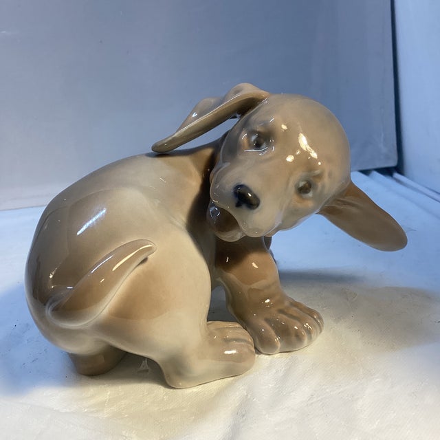 Royal Copenhagen porcelain figurine. Dachshund puppy. Model number 1407. Measures: 5” long x 3.5” wide x 3” tall. In...