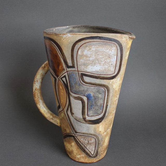 French vintage ceramic pitcher by alexandre kostanda, vallauris, france (circa 1960s). In his trademark natural clay and...