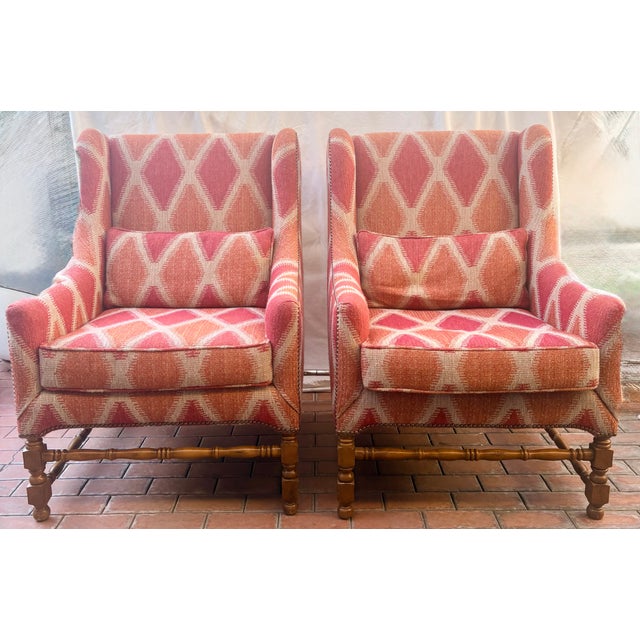 The perfect blend of historic and contemporary design! This pair of reproduction wingback chairs feature design details...