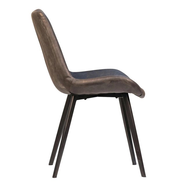 Modern aged grey faux leather upholstered dining chair. This chair has black powder coated iron legs. Each may vary...