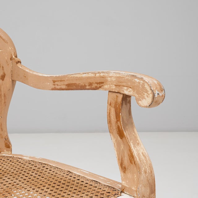 This 1900s French Louis XV-style open armchair presents an elegant silhouette enriched by its beautifully worn patinated...