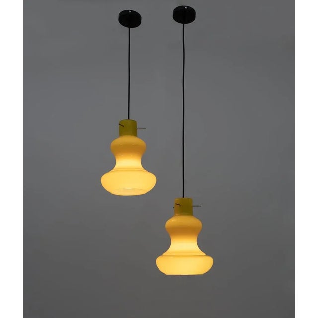 Pair of pendant lamps designed by massimo vignelli for the vistosi glassworks in the 1960s, made of cased murano glass. It...