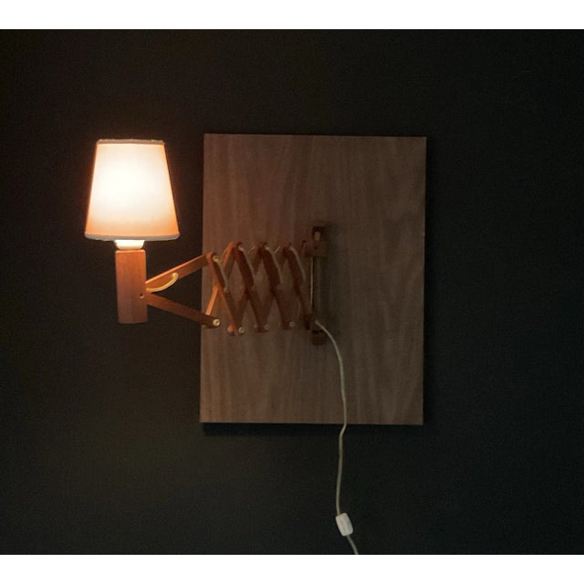 Vintage, Mid Century Modern Danish teak wood scissor lamp. Comes with anchors, screws, finish plugs for easy attachment to...