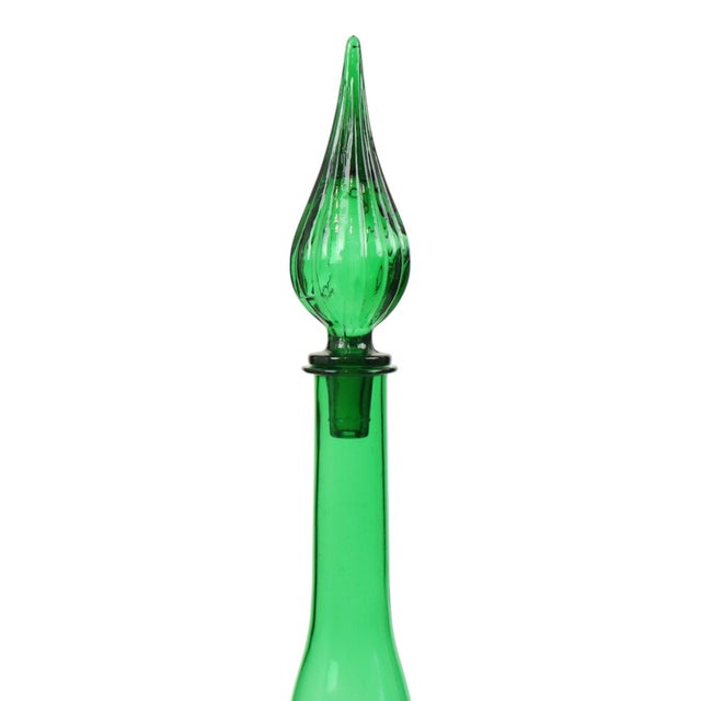 Huge green glass decanter featuring a vertical pattern around the middle and a teardrop-shaped stopper; made by Empoli...