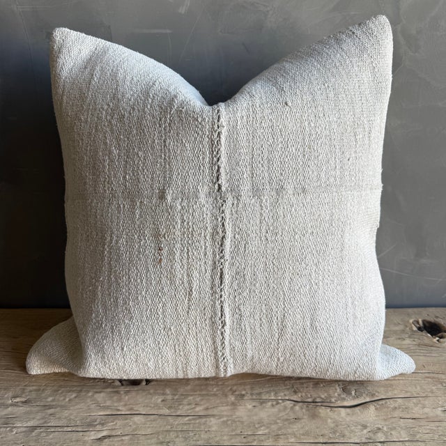 Creamy white hemp rug pillow with original seams. Soft hand, linen blend backing with zipper closure. Spot cleaning is...