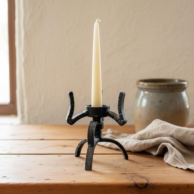 Vintage hand-forged wrought iron candleholder, likely c. 1960s–1970s. Sculptural Brutalist form features a tripod base,...