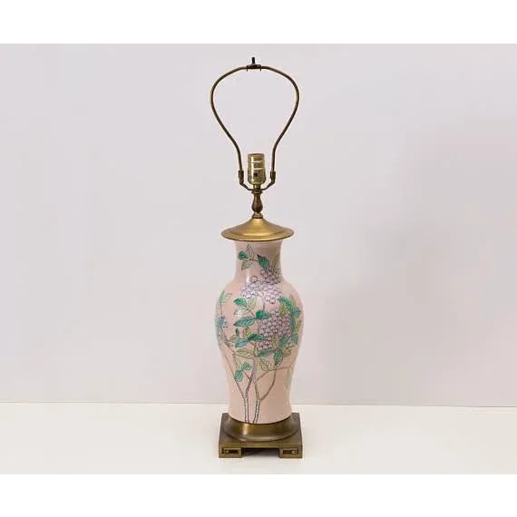 Soft pale pink ceramic is hand painted with Oriental design featuring branches and light purple berries. Brass base stand...