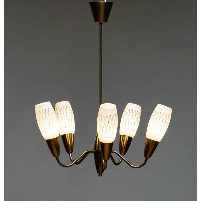 Elegant five arms hanging pendant / fixture in brass with opal art glass from the 1950s. Allover in good condition and...