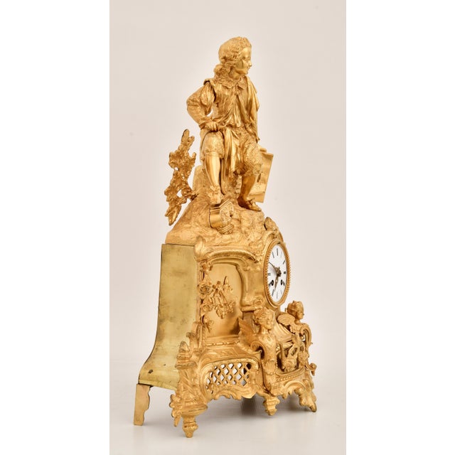 An exceptional French Napoleon III gilt bronze figural mantel clock, dating to the early 19th century, showcasing the...