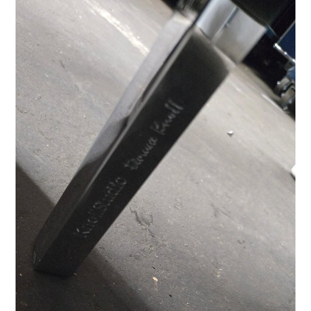 The Florence Knoll Settee Loveseat is a mid-century modern piece with a minimalist, geometric design. It features a tufted...