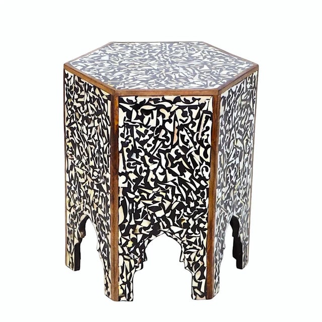 The traditional shape side table gets a contemporary twist with a bold geometric pattern and black hue. Crafted of density...