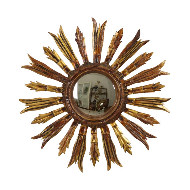Vintage sunburst mirror, made of gilded wood and lacquered plaster, made in Spain around the 1950s. Rare wooden mirror;...