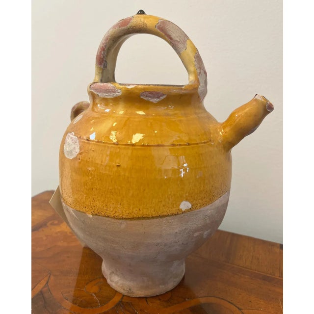 Add instant Provençal charm to your space with this eye-catching 19th-century terracotta wine jug! Hand-thrown and glazed...