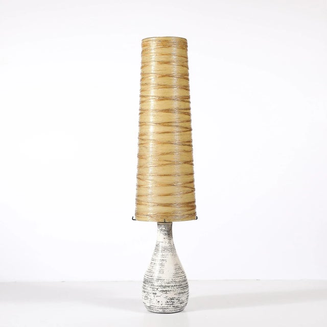 This boldly scaled Mid-Century Modernist table lamp, crafted in France circa 1950 features a harmonious blend of materials...