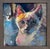 The artwork features a close-up depiction of a cat, rendered in vibrant oil hues that capture the animal's expressive...