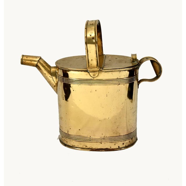 A charming antique brass watering can with a classic cylindrical form and practical design. The body is made from polished...