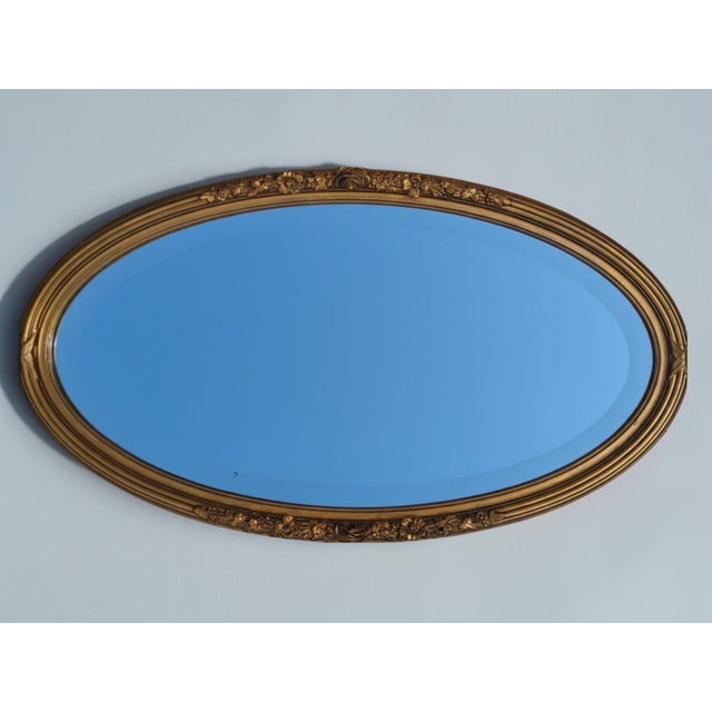 Oval Giltwood Mirror, Louis XVI Style Antique oval mirror with a giltwood and stucco frame, adorned with delicate floral...