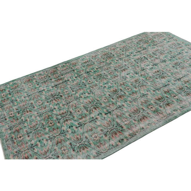 Handknotted in wool, this 5x8 vintage Art deco Zeki Múren runner originates from Turkey, circa 1960-1970 and is latest to...