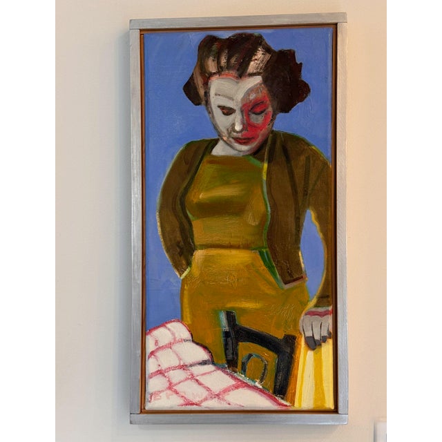 Woman at a café by James Brewer, painted in bold color with a mustard dress and brown jacket against a periwinkle blue...