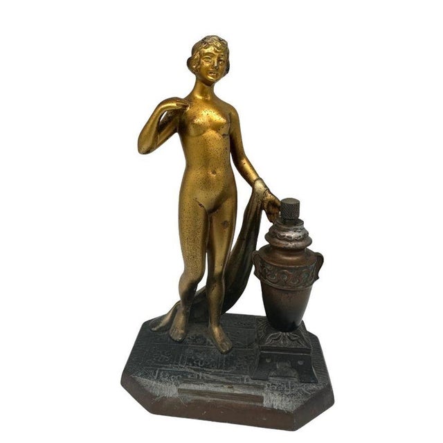 Nude Greek Goddess spelter metal torch tip table lighter featuring a nude flapper gilded in bronze. The urn next to the...