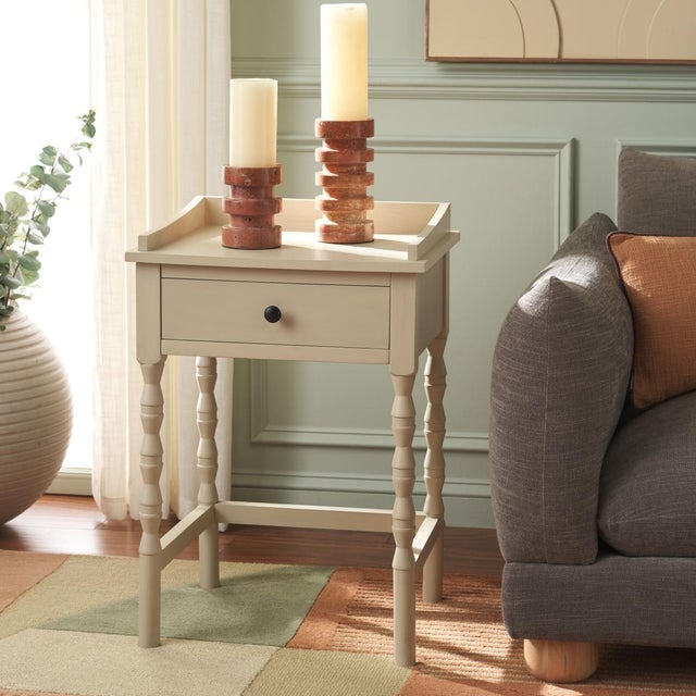 Discover the Astaroth Accent Table in a tranquil Sand color, designed to elevate your living space with its understated...
