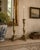 A handsome pair of mid-20th century brass candlesticks with faceted stems, stepped geometric bases, and finely modeled paw...