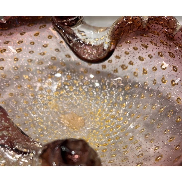 Elegant mid-century art glass bowl from Murano. The organic, softly folded and swirled form is sculpted in an amethyst...