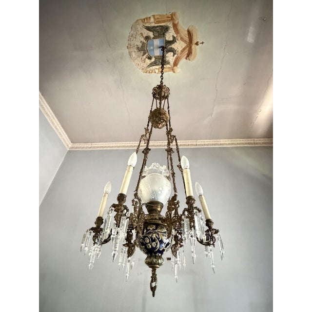 Magnificent seven-light French chandelier, crafted from bronze, majolica, and crystal, dating back to the 1930s. It is...