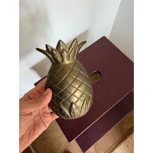 This listing is for a vintage, solid brass pineapple door-knocker. It has holes on the back for securing to the wall. It...