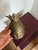 This listing is for a vintage, solid brass pineapple door-knocker. It has holes on the back for securing to the wall. It...