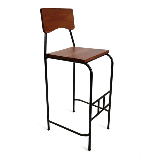 Teak wood and black iron bar stool. Each may vary in exact wood tones, grain, and natural imperfections. Seat height is 29".