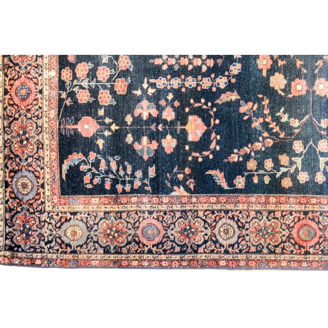 A wonderful and classic early 20th century Persian Sarouk Farahan rug with a traditional mirrored floral pattern woven in...