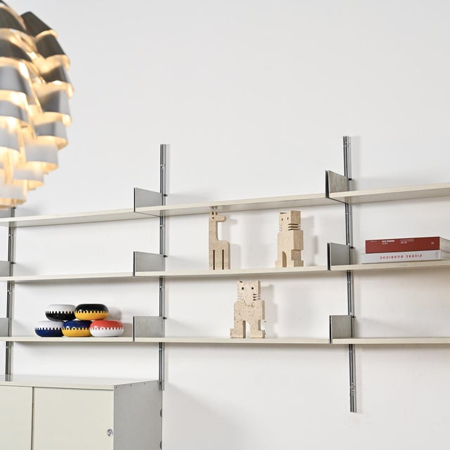 Wall-mounted bookcase model 606 designed by Dieter Rams for Vitsoe in Germany, starting in 1960. Composed of vertical...