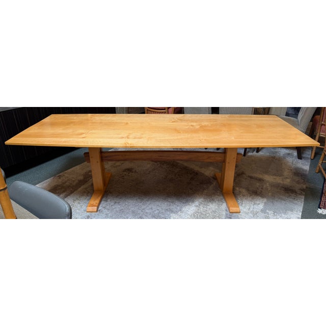 Design Plus Gallery presents a Trestle Dining Room Table with a Boat Shape Tabletop. The dining table is made from Maple...