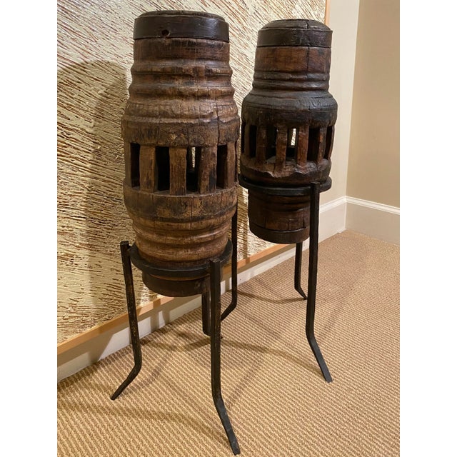 Set of 2 antique cogs on hand forged metal stands. Safe for indoor and outdoor. Cogs are from Thailand and the metal stand...