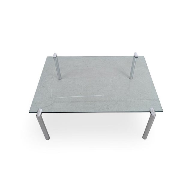 We are offering a beautiful designer coffee table made of glass and metal from the 1980s for sale. The design, and...