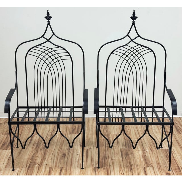 Beautiful pair of Gothic Cathedral style throne chairs. Constructed from durable wrought iron and painted black satin....