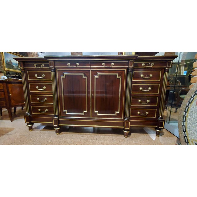 Antique Napoleon III walnut sideboard, French-made. This high-quality piece features brass-covered wooden frames and four...