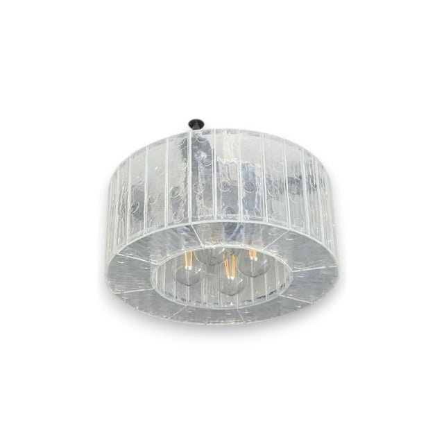 Clear kiln-formed glass McEwen Lighting Sonus Surface Mount with a fabricated Lucite frame and dark-finished copper...