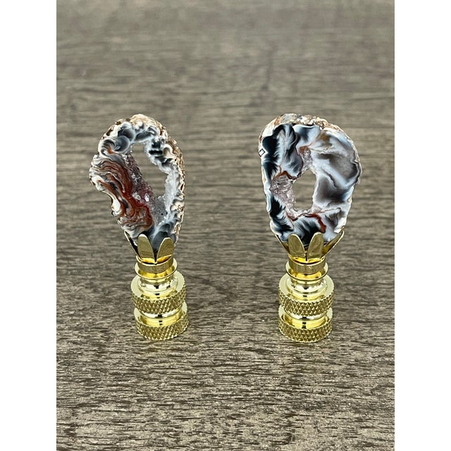 Gorgeous natures beauty agate geode slices mounted on pronged brass bases as lamp finials.