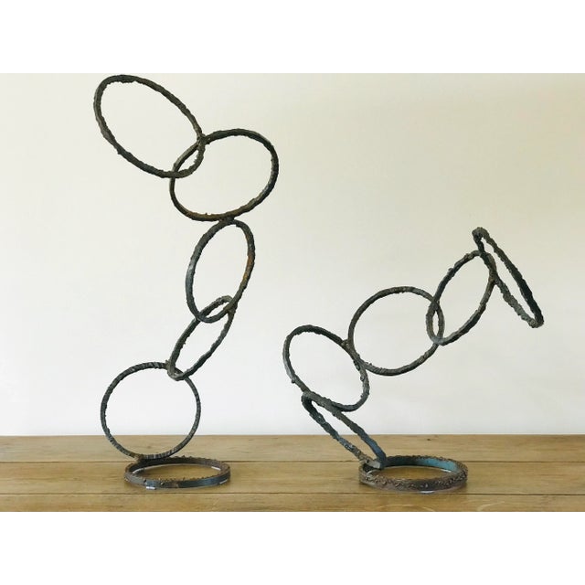A sculpture comprised of welded steel rings in two parts. The separate elements of the work allow it to be positioned in...