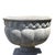 An antique cast stone garden urn presents a classical silhouette, characterized by its elegant melon-ribbed body and a...
