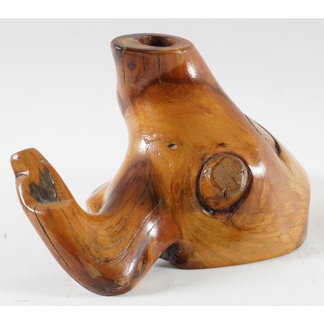 It is crafted from solid wood, featuring a natural finish and prominent wood grain and knots. The design is abstract and...