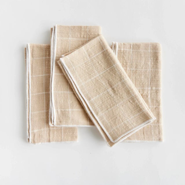 Bring a touch of softness to the table with this set of four cotton napkins. Beautiful in tone and texture, the soft taupe...