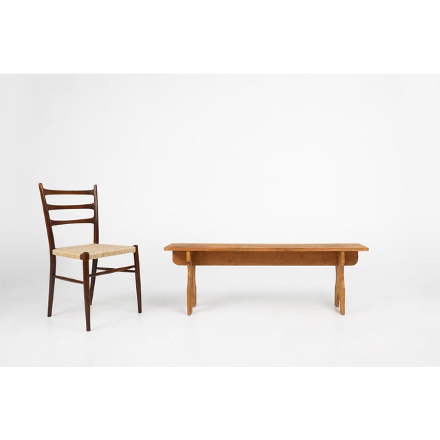 A beautifully honest French wooden bench from around 1940, crafted in solid wood with a warm, natural patina that reveals...