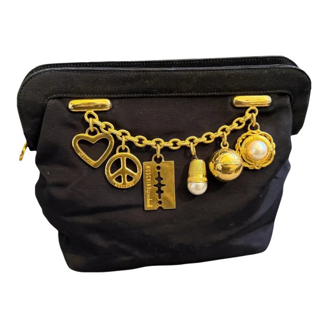 1980s Iconic Black Fabric and Brass Charms Clutch by Franco Moschino For Sale